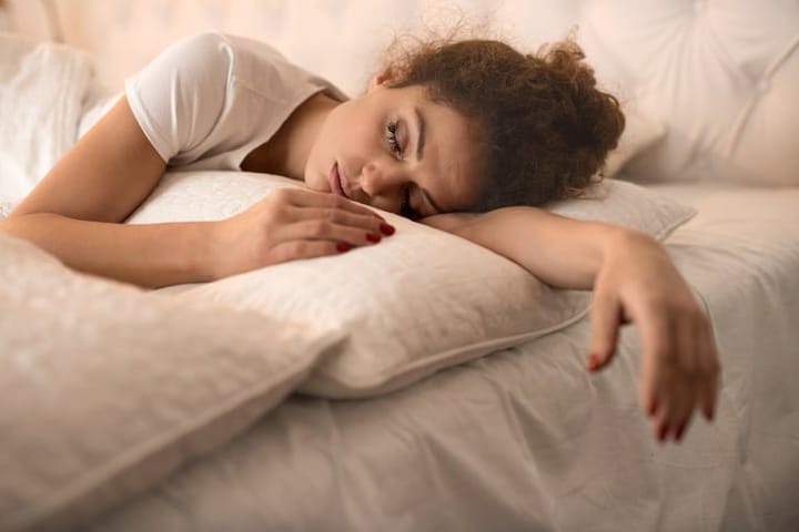 Young woman sleeping in bed.