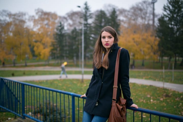 woman looking concerned standing in park