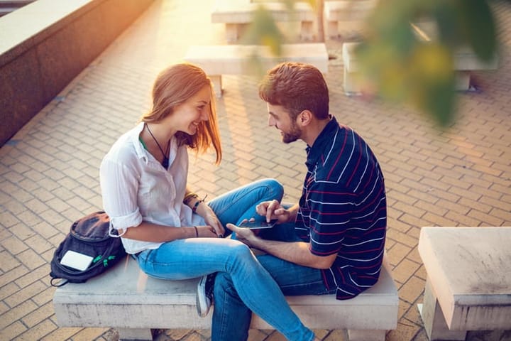 Couple talking on a bench