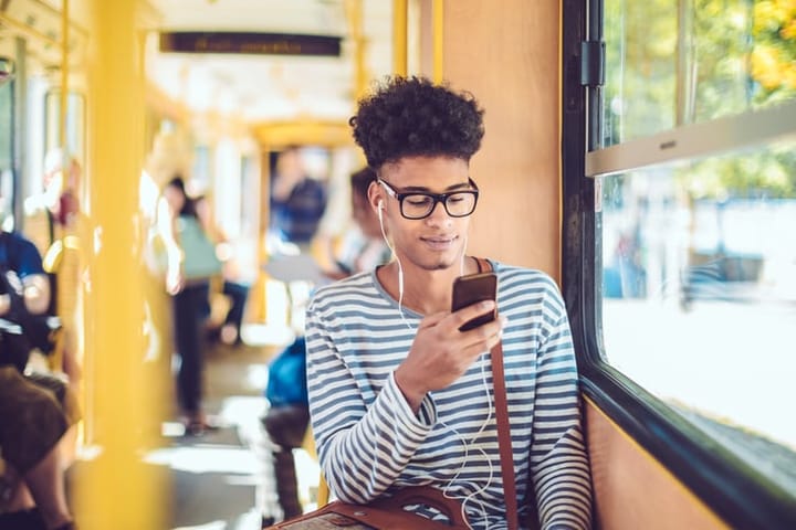 black man afro hair using smart phone