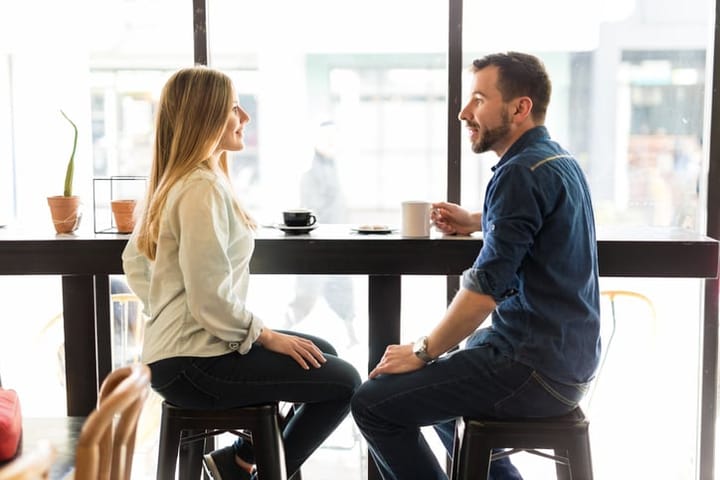 couple on a date sitting near window