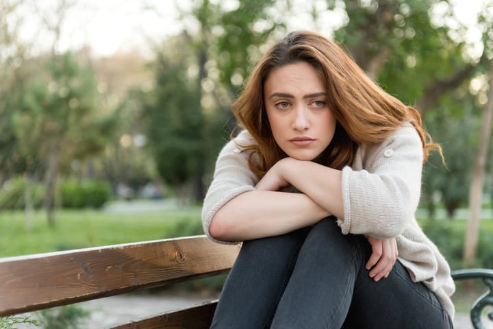 woman upset on a bench