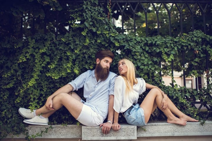 Young loving couple looking at each other outdoors.