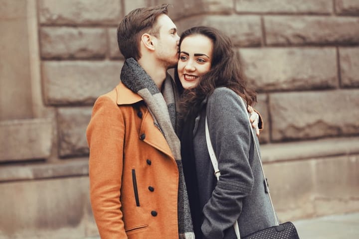 Young couple embracing and kissing in the city
