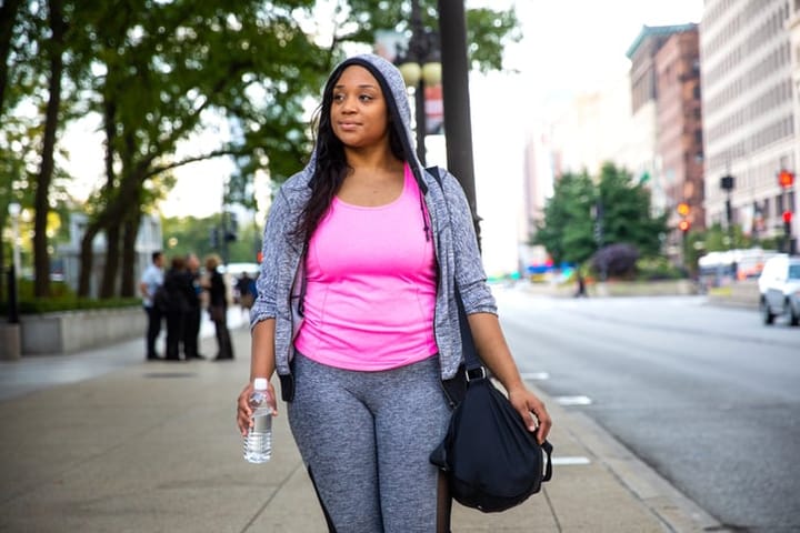 black woman in gymwear outside