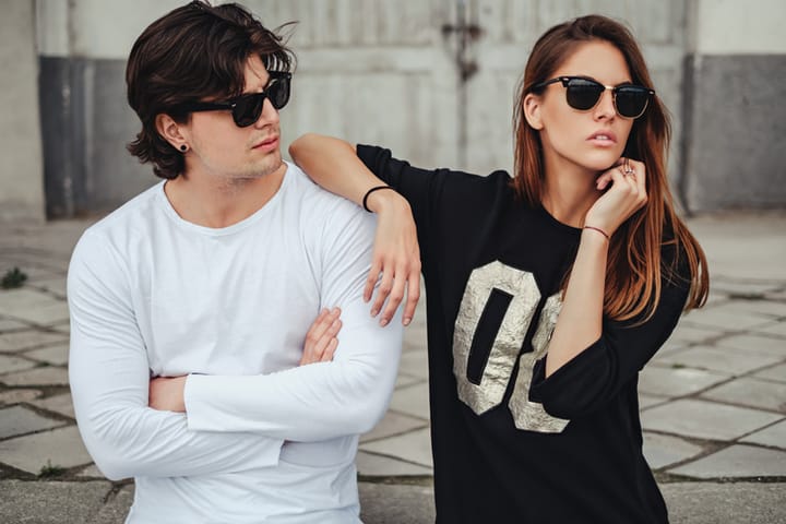 Cool couple with attitude posing outside