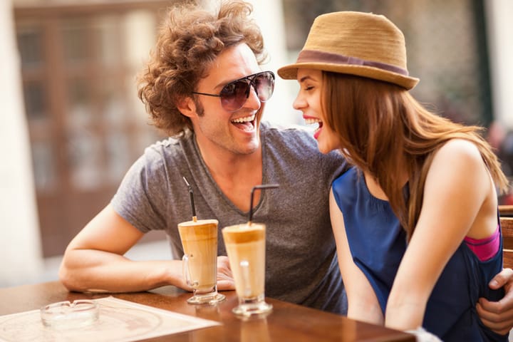 couple smiling at a coffee shop