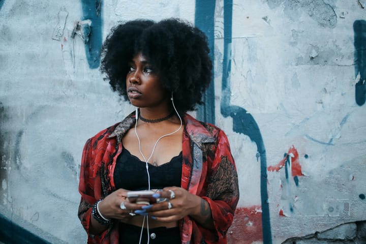 black woman holding smart phone