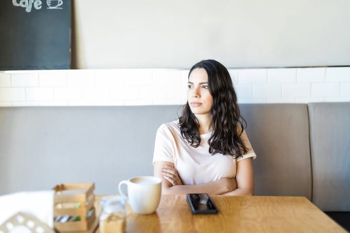 woman looking pensive at cafe
