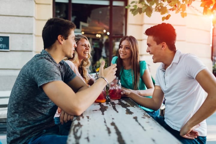 Group of friends enjoying drinks in cafe together