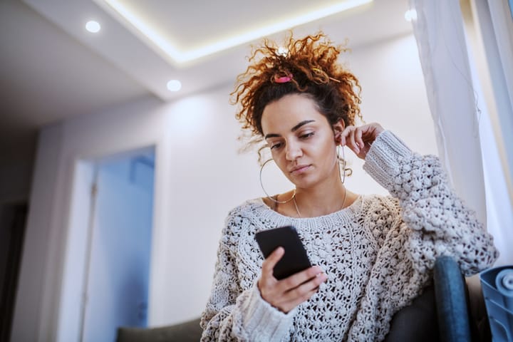 Attractive Caucasian tanned brunette with mobile