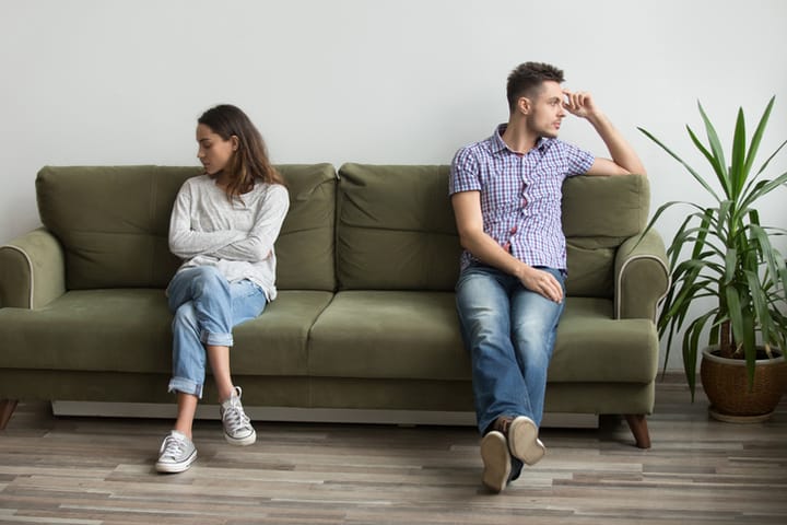 couple on couch in a fight