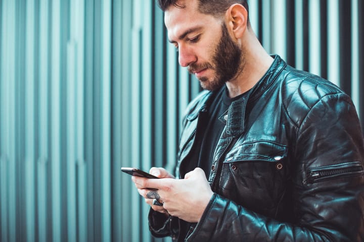 serious man texting on phone