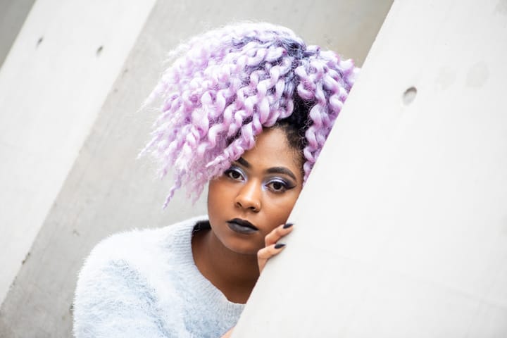 african american woman with purple curly hair