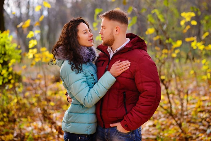 couple in padded winter coats outside