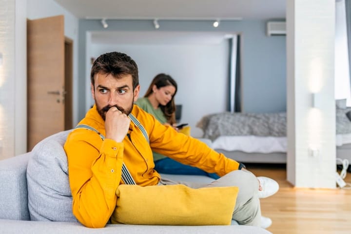 annoyed man looking away from girlfriend