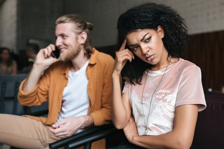 mixed race couple looking bored