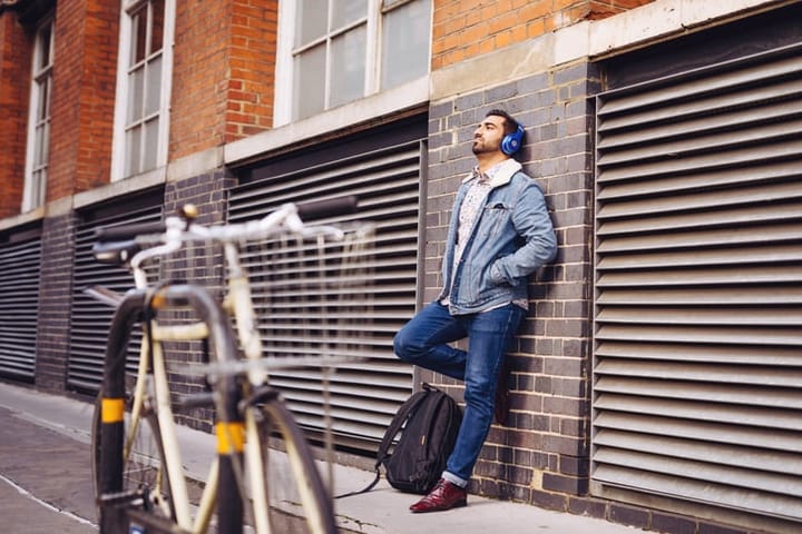 man leaning up against a wall