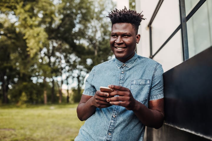 black man holding his mobile