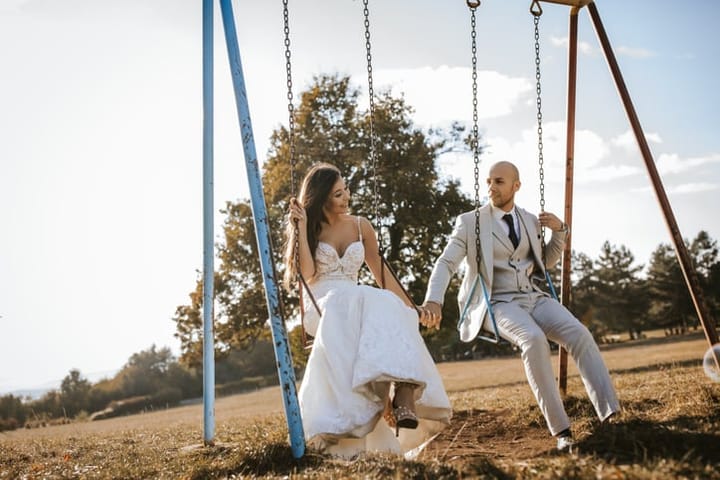 couple sitting on swings married
