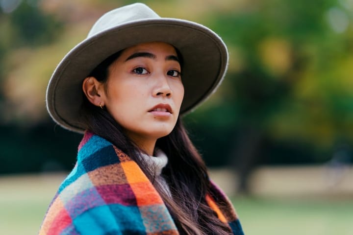 asian woman in a hat and scarf