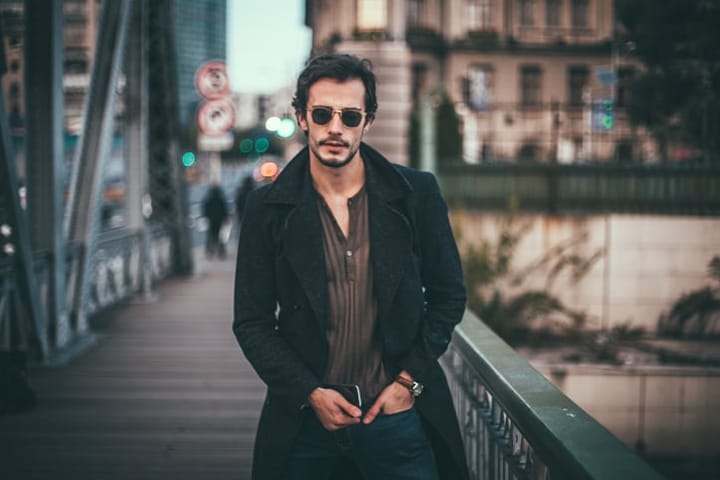 guy sunglasses black coat in the city