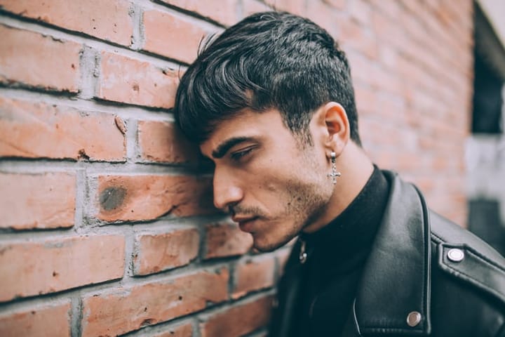 Sad young guy in black clothes