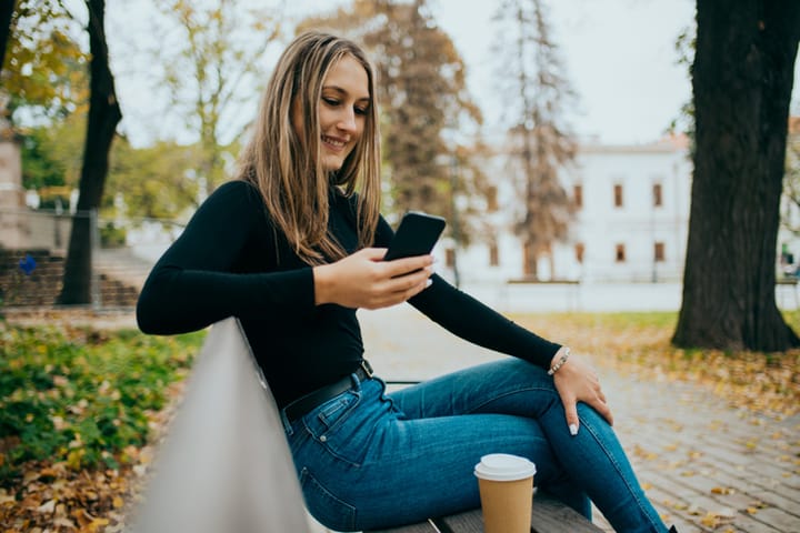 woman phone bench