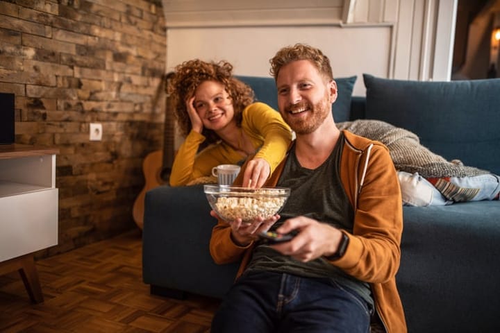 couple at home with popcorn