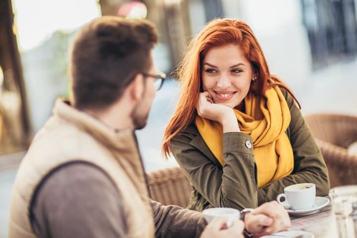 romantic couple outside having coffee