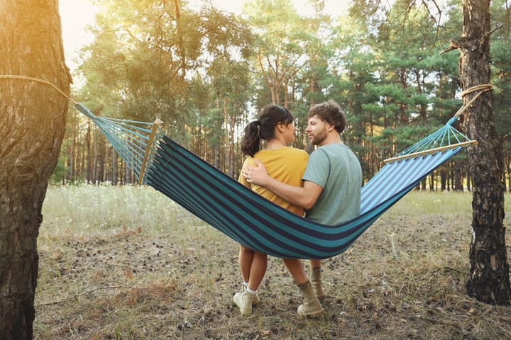 couple sitting on hammock chatting