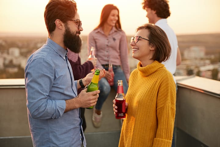 man and woman having a converesation on rooftop