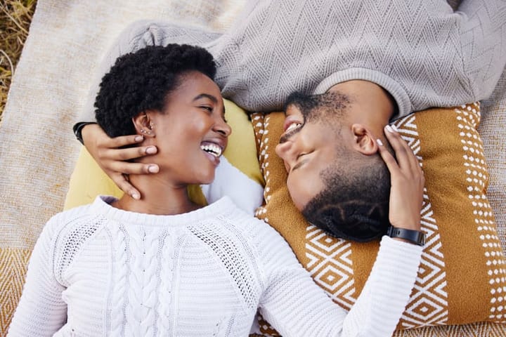 Shot of a young couple laying on a rug