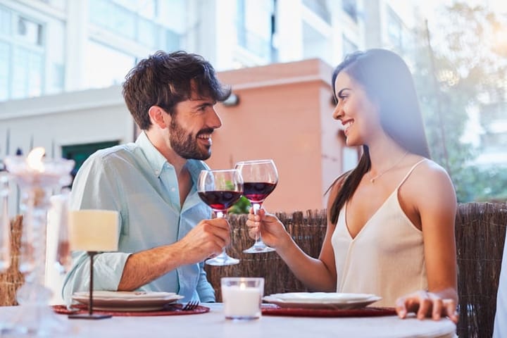 couple at a bar drinking wine