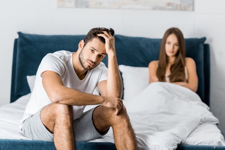 couple in bed relationship problems