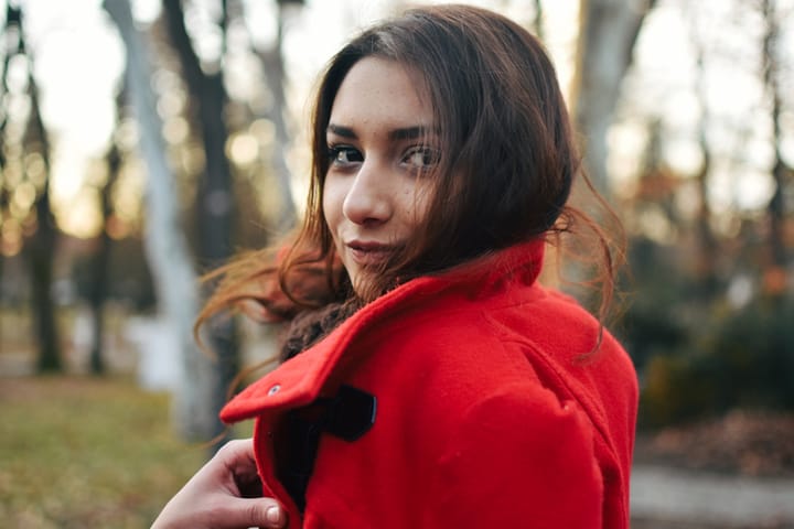 brunette woman forest red coat