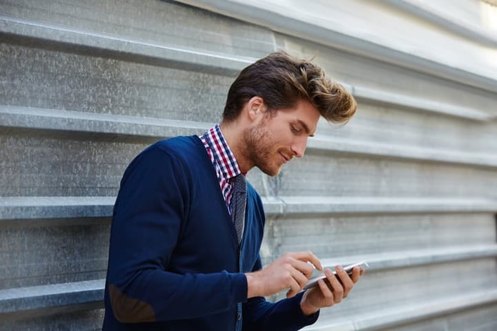 attractive male using a smartphone