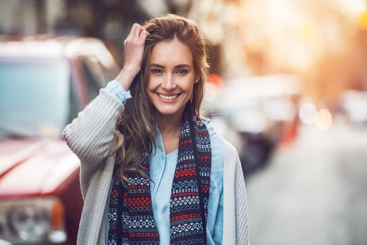 smiling woman wearing a scarf