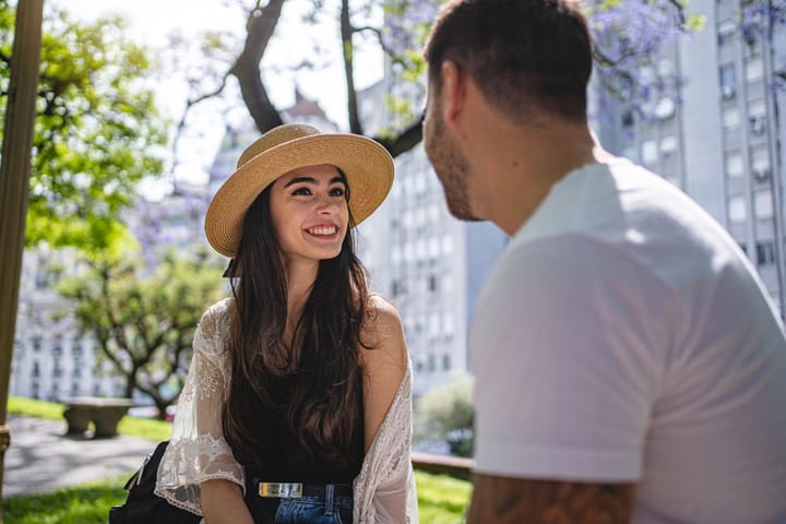 long haired brunette woman on a date wearing hat
