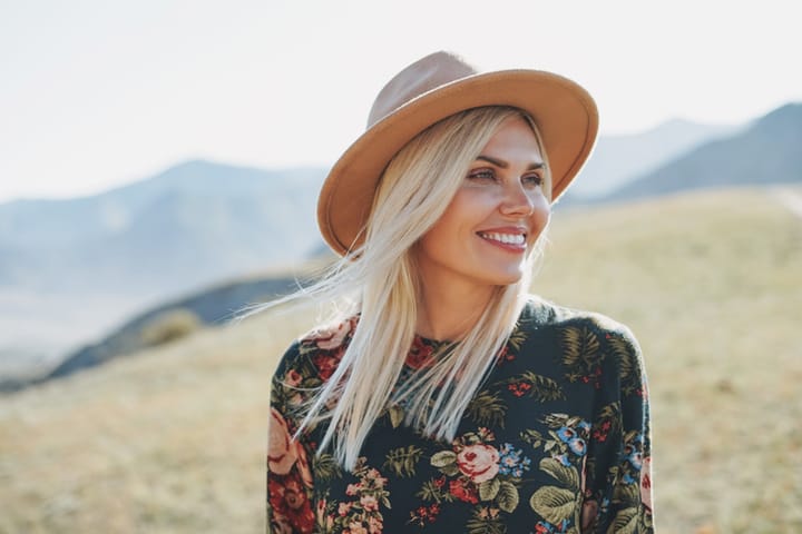 blonde woman with hat outside