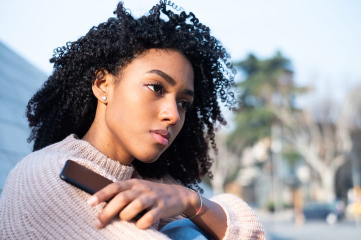 young black woman sitting thoughtful