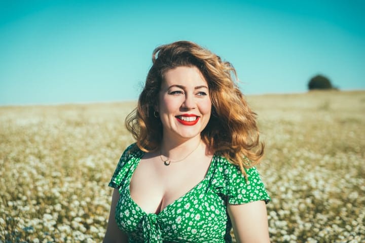 woman outside in a field of poppies