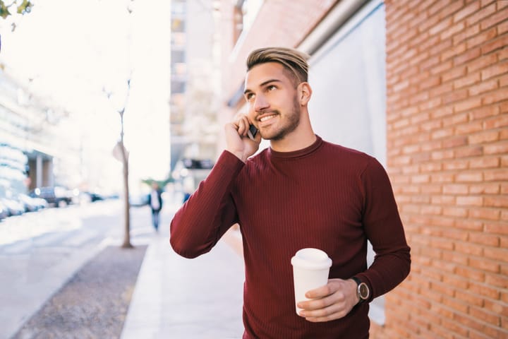 young man beard using mobile