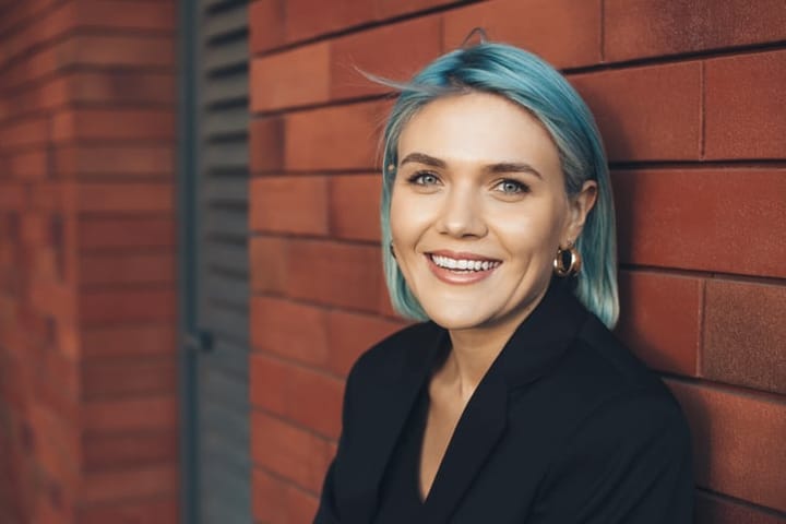 smiling woman with blue hair