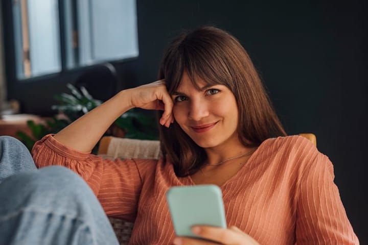 flirting woman sitting alone with mobile
