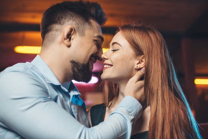 man seducing woman with kiss