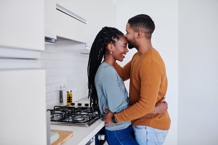couple affectionate in kitchen
