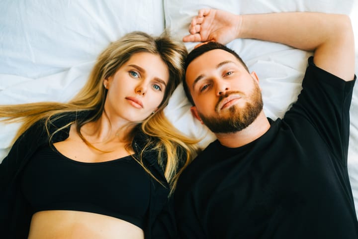 couple laying down not talking