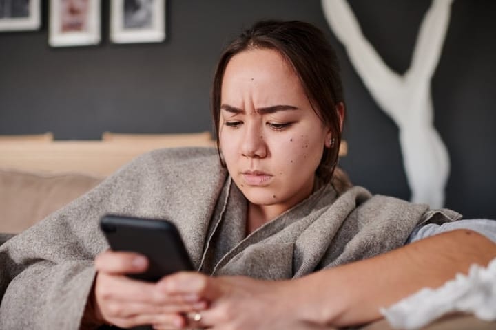 frustrated woman texting on smartphone