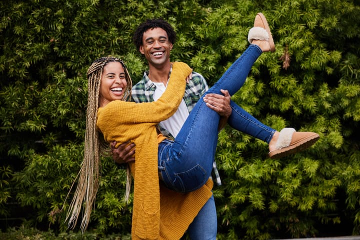 happy Black couple smiling outside